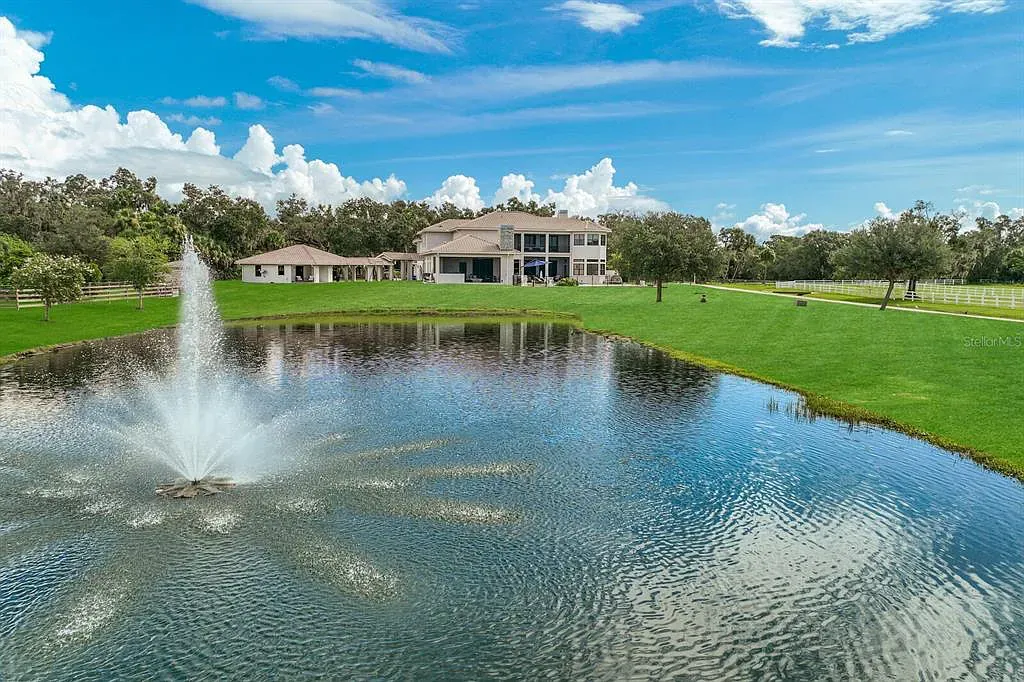 5952 Vanderipe Road Home in Sarasota, Florida. Discover luxurious country living at its finest in this custom-designed home nestled on a sprawling equestrian estate in Myakka Valley Ranches. With over 12 acres of land, two separate lots, and a meticulously crafted residence boasting modern amenities, this property offers a canvas for your dreams to flourish.