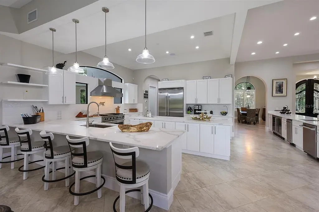 5952 Vanderipe Road Home in Sarasota, Florida. Discover luxurious country living at its finest in this custom-designed home nestled on a sprawling equestrian estate in Myakka Valley Ranches. With over 12 acres of land, two separate lots, and a meticulously crafted residence boasting modern amenities, this property offers a canvas for your dreams to flourish.