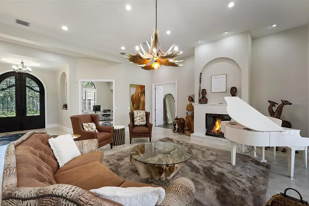 5952 Vanderipe Road Home in Sarasota, Florida. Discover luxurious country living at its finest in this custom-designed home nestled on a sprawling equestrian estate in Myakka Valley Ranches. With over 12 acres of land, two separate lots, and a meticulously crafted residence boasting modern amenities, this property offers a canvas for your dreams to flourish.