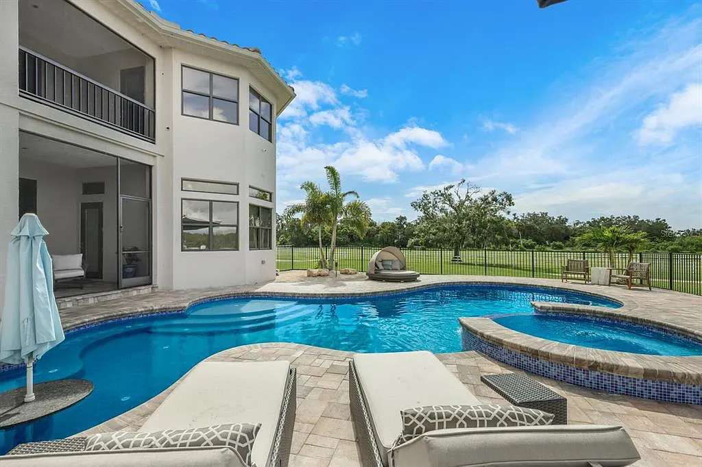5952 Vanderipe Road Home in Sarasota, Florida. Discover luxurious country living at its finest in this custom-designed home nestled on a sprawling equestrian estate in Myakka Valley Ranches. With over 12 acres of land, two separate lots, and a meticulously crafted residence boasting modern amenities, this property offers a canvas for your dreams to flourish.