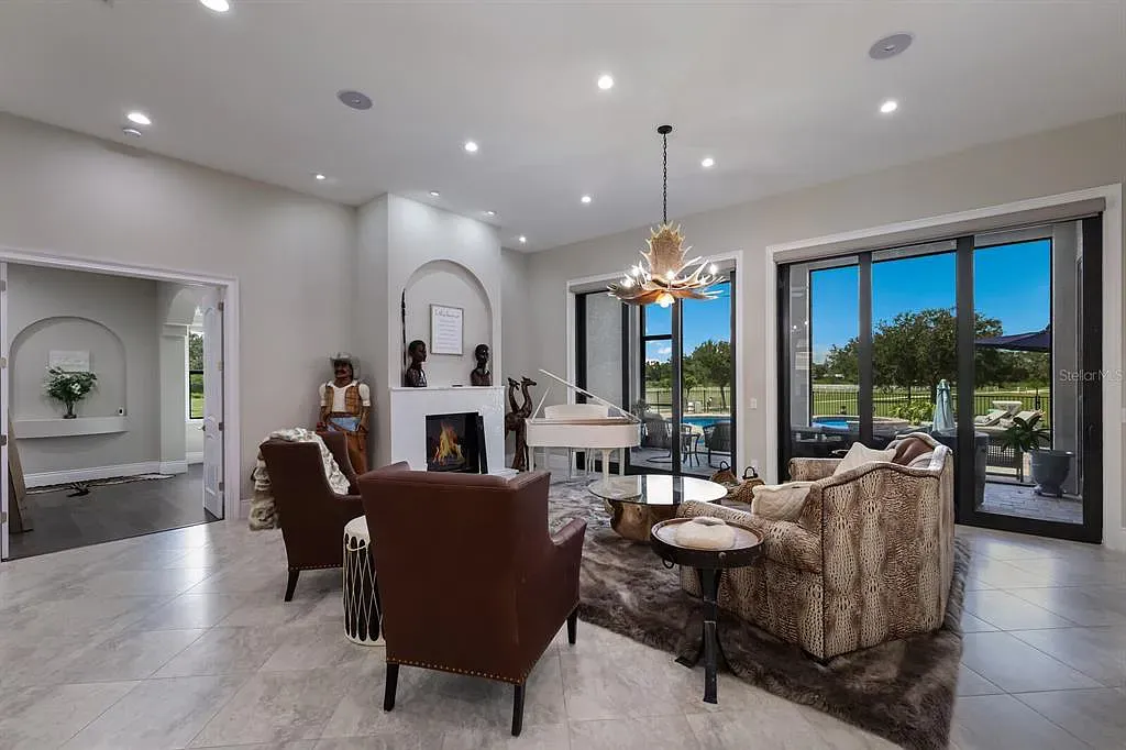 5952 Vanderipe Road Home in Sarasota, Florida. Discover luxurious country living at its finest in this custom-designed home nestled on a sprawling equestrian estate in Myakka Valley Ranches. With over 12 acres of land, two separate lots, and a meticulously crafted residence boasting modern amenities, this property offers a canvas for your dreams to flourish.