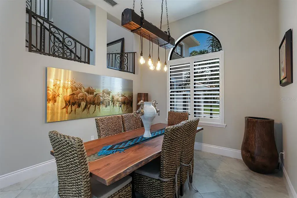 5952 Vanderipe Road Home in Sarasota, Florida. Discover luxurious country living at its finest in this custom-designed home nestled on a sprawling equestrian estate in Myakka Valley Ranches. With over 12 acres of land, two separate lots, and a meticulously crafted residence boasting modern amenities, this property offers a canvas for your dreams to flourish.