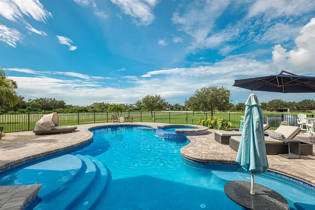 5952 Vanderipe Road Home in Sarasota, Florida. Discover luxurious country living at its finest in this custom-designed home nestled on a sprawling equestrian estate in Myakka Valley Ranches. With over 12 acres of land, two separate lots, and a meticulously crafted residence boasting modern amenities, this property offers a canvas for your dreams to flourish.