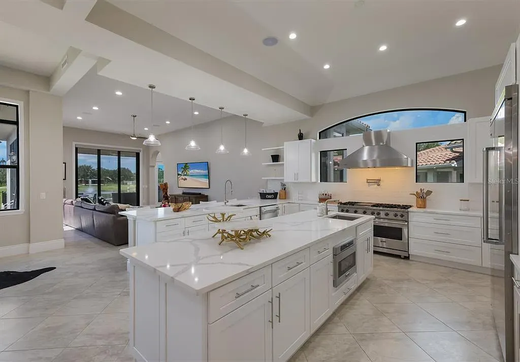 5952 Vanderipe Road Home in Sarasota, Florida. Discover luxurious country living at its finest in this custom-designed home nestled on a sprawling equestrian estate in Myakka Valley Ranches. With over 12 acres of land, two separate lots, and a meticulously crafted residence boasting modern amenities, this property offers a canvas for your dreams to flourish.