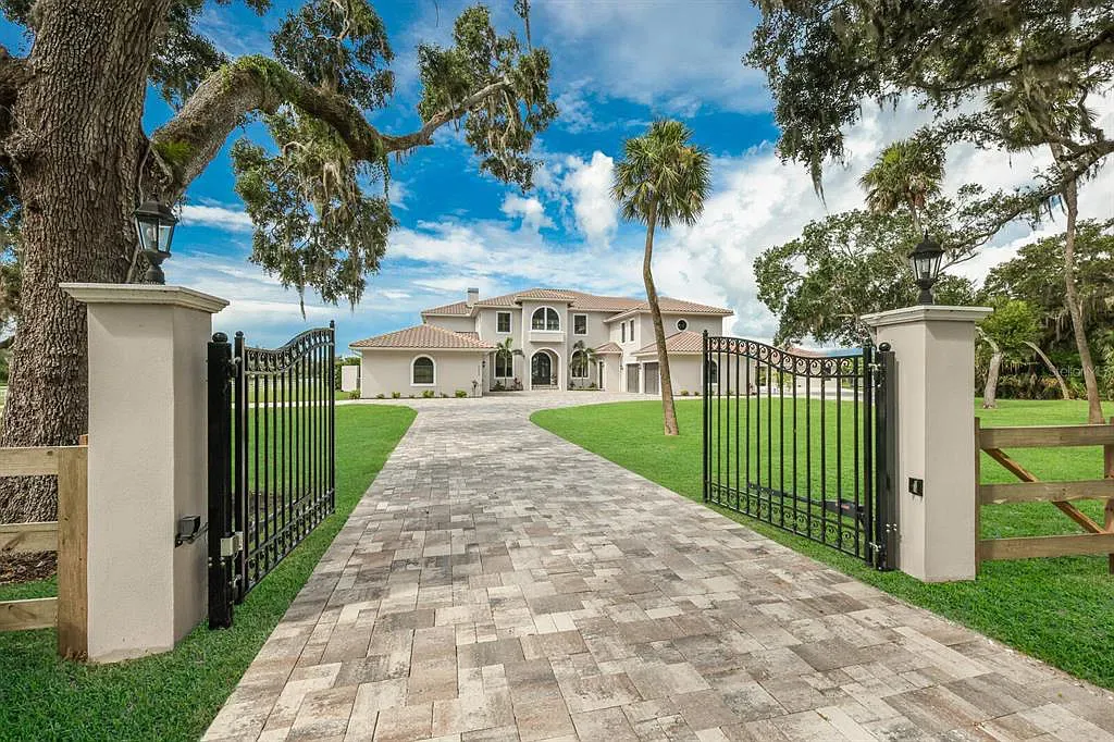 5952 Vanderipe Road Home in Sarasota, Florida. Discover luxurious country living at its finest in this custom-designed home nestled on a sprawling equestrian estate in Myakka Valley Ranches. With over 12 acres of land, two separate lots, and a meticulously crafted residence boasting modern amenities, this property offers a canvas for your dreams to flourish.