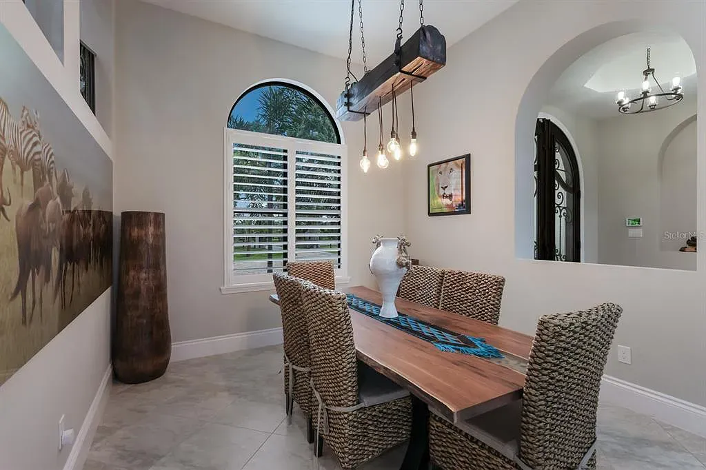 5952 Vanderipe Road Home in Sarasota, Florida. Discover luxurious country living at its finest in this custom-designed home nestled on a sprawling equestrian estate in Myakka Valley Ranches. With over 12 acres of land, two separate lots, and a meticulously crafted residence boasting modern amenities, this property offers a canvas for your dreams to flourish.