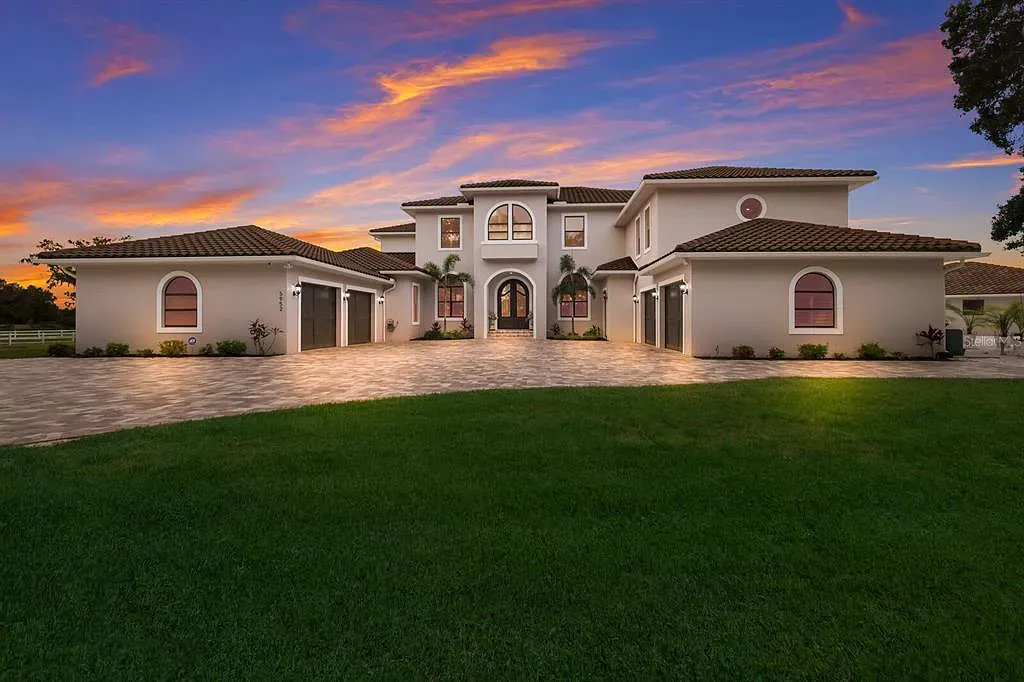 5952 Vanderipe Road Home in Sarasota, Florida. Discover luxurious country living at its finest in this custom-designed home nestled on a sprawling equestrian estate in Myakka Valley Ranches. With over 12 acres of land, two separate lots, and a meticulously crafted residence boasting modern amenities, this property offers a canvas for your dreams to flourish.