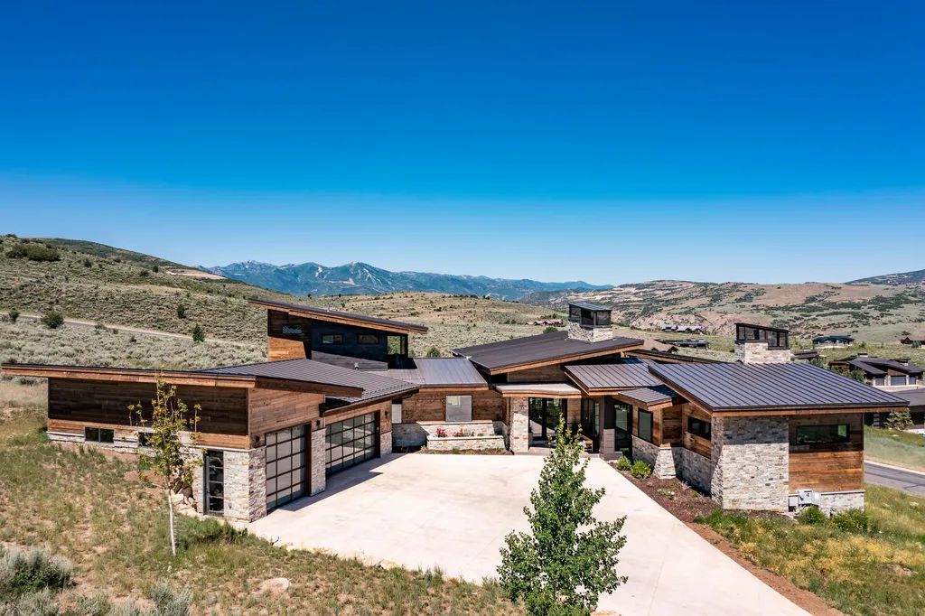 6110 E Blue Wing Loop Home in Kamas, Utah. Immerse yourself in the grandeur of Utah's natural beauty at 6110 E Blue Wing in Victory Ranch. This modern mountain home offers breathtaking 180° views of mountains, Deer Valley ski resort, and rock cliffs from every room.