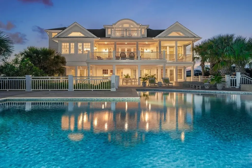 7 Cowrie Lane Home in Wrightsville Beach, North Carolina. Discover the epitome of luxurious coastal living at this expansive oceanfront estate in Wrightsville Beach. Set on nearly one acre of pristine land, this majestic property features a resort-style pool, lush landscaping, and private beach access. 