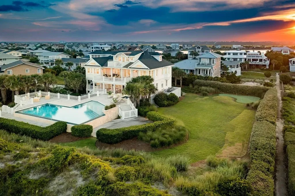 7 Cowrie Lane Home in Wrightsville Beach, North Carolina. Discover the epitome of luxurious coastal living at this expansive oceanfront estate in Wrightsville Beach. Set on nearly one acre of pristine land, this majestic property features a resort-style pool, lush landscaping, and private beach access. 