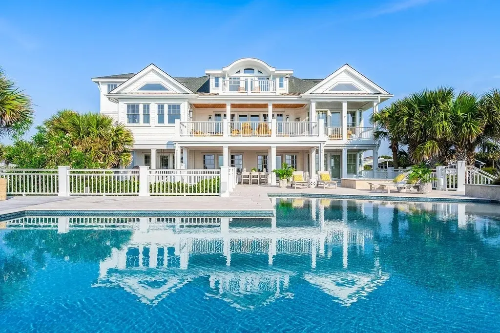 7 Cowrie Lane Home in Wrightsville Beach, North Carolina. Discover the epitome of luxurious coastal living at this expansive oceanfront estate in Wrightsville Beach. Set on nearly one acre of pristine land, this majestic property features a resort-style pool, lush landscaping, and private beach access. 