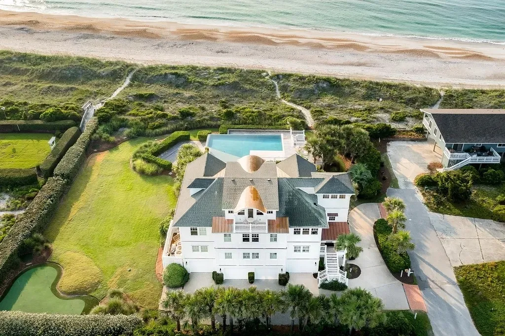 7 Cowrie Lane Home in Wrightsville Beach, North Carolina. Discover the epitome of luxurious coastal living at this expansive oceanfront estate in Wrightsville Beach. Set on nearly one acre of pristine land, this majestic property features a resort-style pool, lush landscaping, and private beach access. 