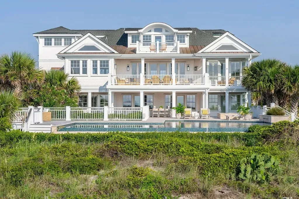 7 Cowrie Lane Home in Wrightsville Beach, North Carolina. Discover the epitome of luxurious coastal living at this expansive oceanfront estate in Wrightsville Beach. Set on nearly one acre of pristine land, this majestic property features a resort-style pool, lush landscaping, and private beach access. 
