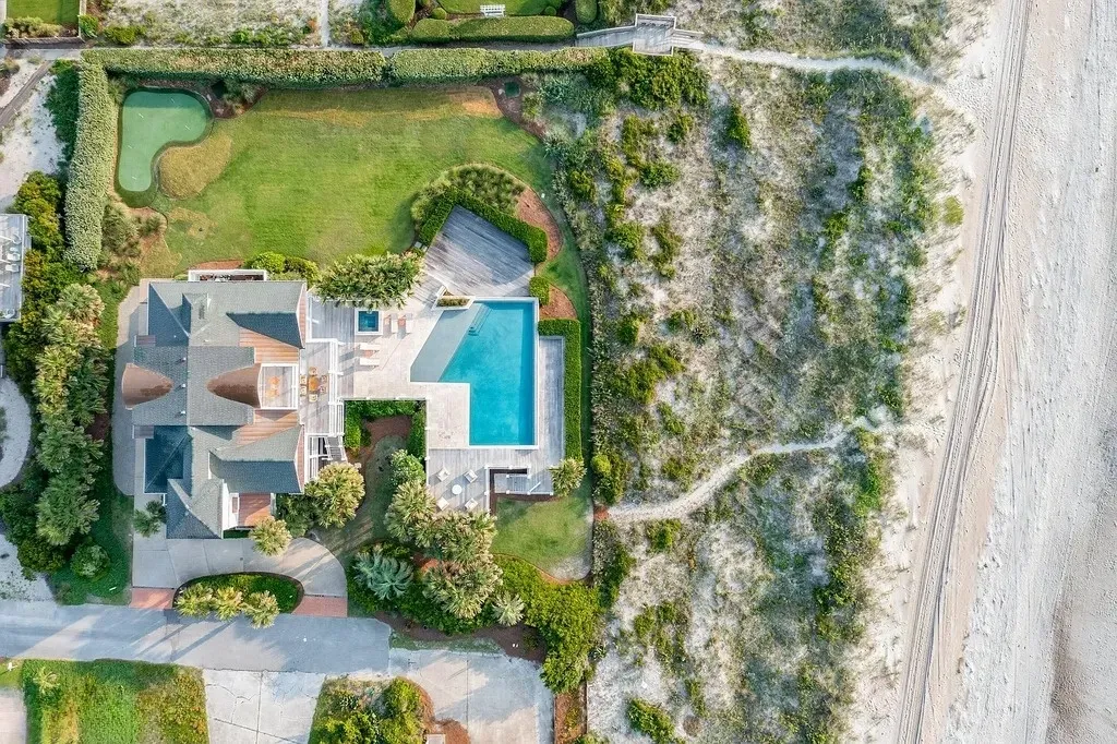 7 Cowrie Lane Home in Wrightsville Beach, North Carolina. Discover the epitome of luxurious coastal living at this expansive oceanfront estate in Wrightsville Beach. Set on nearly one acre of pristine land, this majestic property features a resort-style pool, lush landscaping, and private beach access. 