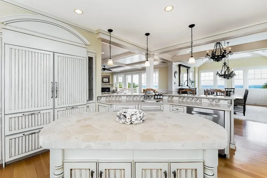 7 Cowrie Lane Home in Wrightsville Beach, North Carolina. Discover the epitome of luxurious coastal living at this expansive oceanfront estate in Wrightsville Beach. Set on nearly one acre of pristine land, this majestic property features a resort-style pool, lush landscaping, and private beach access. 