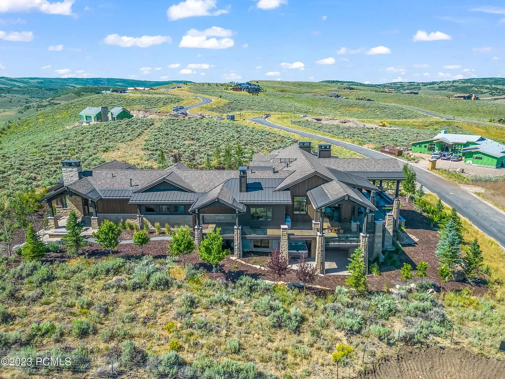 7672 East Moon Dance Circle Home in Heber, Utah. Discover the epitome of modern mountain living within the prestigious gated enclave of Victory Ranch. This unique custom home offers unparalleled views throughout the changing seasons, inviting residents to reconnect with nature and relish in top-tier amenities. Experience the perfect multigenerational mountain retreat, seamlessly blending indoor and outdoor living. With direct access to Victory Ranch's extensive backcountry trails, outdoor adventures are just steps away.