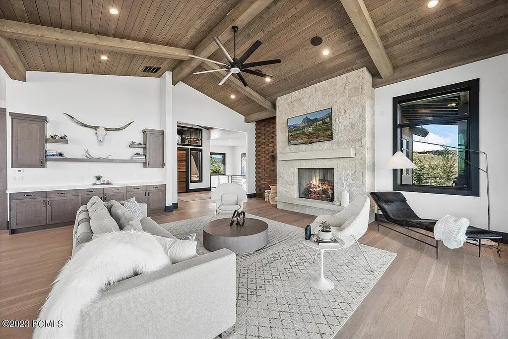 7672 East Moon Dance Circle Home in Heber, Utah. Discover the epitome of modern mountain living within the prestigious gated enclave of Victory Ranch. This unique custom home offers unparalleled views throughout the changing seasons, inviting residents to reconnect with nature and relish in top-tier amenities. Experience the perfect multigenerational mountain retreat, seamlessly blending indoor and outdoor living. With direct access to Victory Ranch's extensive backcountry trails, outdoor adventures are just steps away.