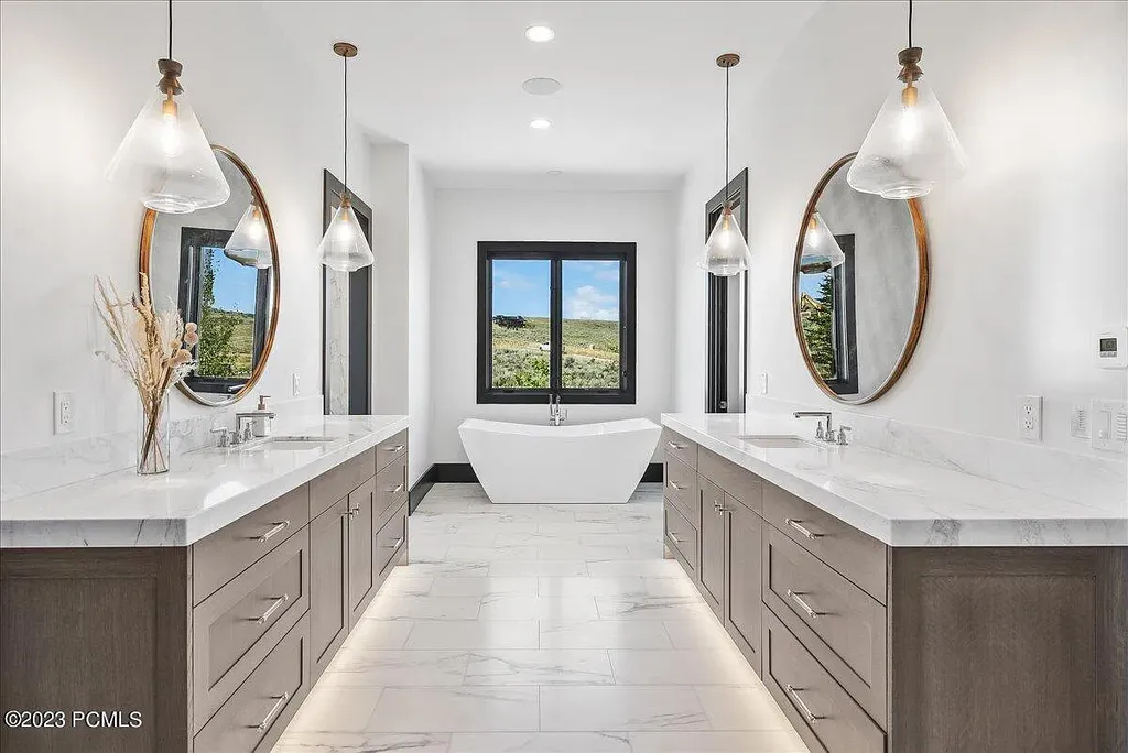 7672 East Moon Dance Circle Home in Heber, Utah. Discover the epitome of modern mountain living within the prestigious gated enclave of Victory Ranch. This unique custom home offers unparalleled views throughout the changing seasons, inviting residents to reconnect with nature and relish in top-tier amenities. Experience the perfect multigenerational mountain retreat, seamlessly blending indoor and outdoor living. With direct access to Victory Ranch's extensive backcountry trails, outdoor adventures are just steps away.