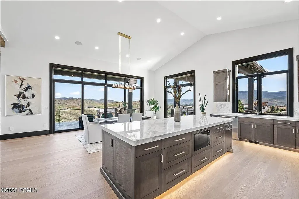7672 East Moon Dance Circle Home in Heber, Utah. Discover the epitome of modern mountain living within the prestigious gated enclave of Victory Ranch. This unique custom home offers unparalleled views throughout the changing seasons, inviting residents to reconnect with nature and relish in top-tier amenities. Experience the perfect multigenerational mountain retreat, seamlessly blending indoor and outdoor living. With direct access to Victory Ranch's extensive backcountry trails, outdoor adventures are just steps away.