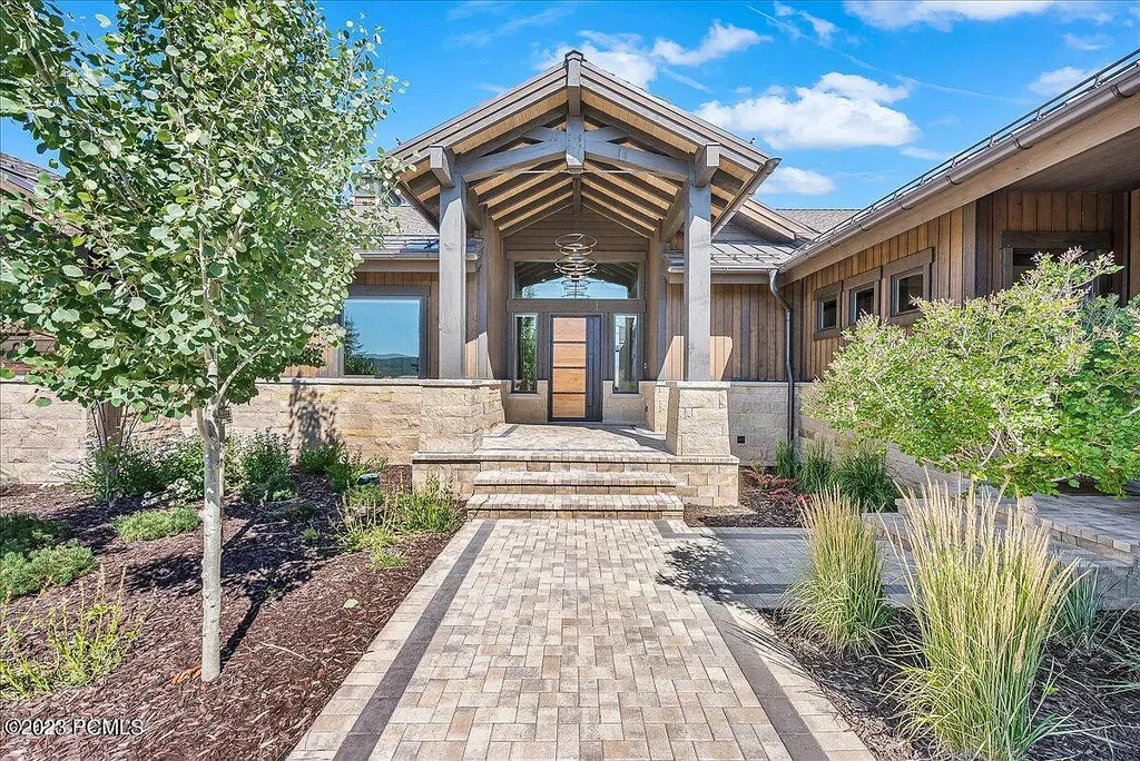 7672 East Moon Dance Circle Home in Heber, Utah. Discover the epitome of modern mountain living within the prestigious gated enclave of Victory Ranch. This unique custom home offers unparalleled views throughout the changing seasons, inviting residents to reconnect with nature and relish in top-tier amenities. Experience the perfect multigenerational mountain retreat, seamlessly blending indoor and outdoor living. With direct access to Victory Ranch's extensive backcountry trails, outdoor adventures are just steps away.