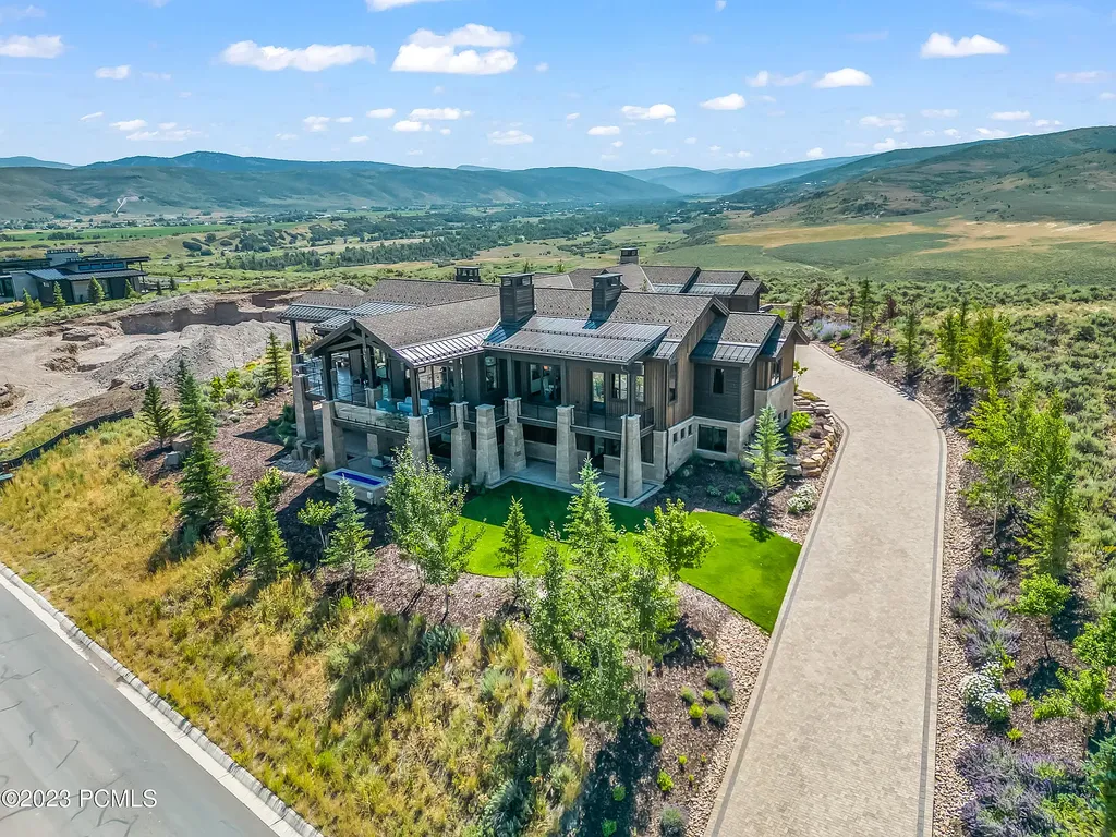 7672 East Moon Dance Circle Home in Heber, Utah. Discover the epitome of modern mountain living within the prestigious gated enclave of Victory Ranch. This unique custom home offers unparalleled views throughout the changing seasons, inviting residents to reconnect with nature and relish in top-tier amenities. Experience the perfect multigenerational mountain retreat, seamlessly blending indoor and outdoor living. With direct access to Victory Ranch's extensive backcountry trails, outdoor adventures are just steps away.