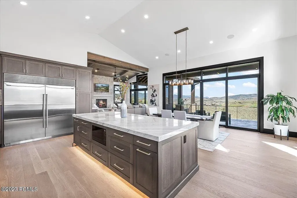 7672 East Moon Dance Circle Home in Heber, Utah. Discover the epitome of modern mountain living within the prestigious gated enclave of Victory Ranch. This unique custom home offers unparalleled views throughout the changing seasons, inviting residents to reconnect with nature and relish in top-tier amenities. Experience the perfect multigenerational mountain retreat, seamlessly blending indoor and outdoor living. With direct access to Victory Ranch's extensive backcountry trails, outdoor adventures are just steps away.