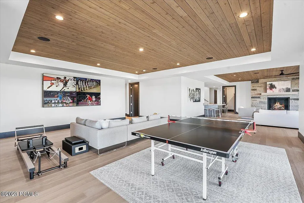 7672 East Moon Dance Circle Home in Heber, Utah. Discover the epitome of modern mountain living within the prestigious gated enclave of Victory Ranch. This unique custom home offers unparalleled views throughout the changing seasons, inviting residents to reconnect with nature and relish in top-tier amenities. Experience the perfect multigenerational mountain retreat, seamlessly blending indoor and outdoor living. With direct access to Victory Ranch's extensive backcountry trails, outdoor adventures are just steps away.
