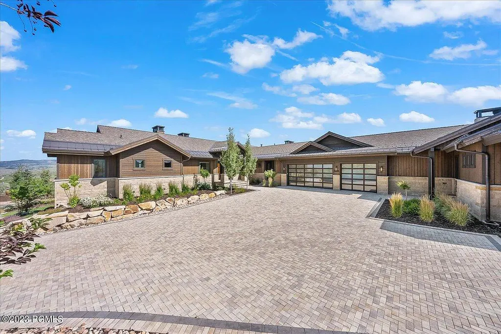 7672 East Moon Dance Circle Home in Heber, Utah. Discover the epitome of modern mountain living within the prestigious gated enclave of Victory Ranch. This unique custom home offers unparalleled views throughout the changing seasons, inviting residents to reconnect with nature and relish in top-tier amenities. Experience the perfect multigenerational mountain retreat, seamlessly blending indoor and outdoor living. With direct access to Victory Ranch's extensive backcountry trails, outdoor adventures are just steps away.