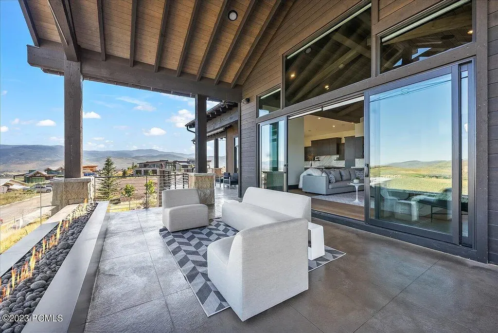 7672 East Moon Dance Circle Home in Heber, Utah. Discover the epitome of modern mountain living within the prestigious gated enclave of Victory Ranch. This unique custom home offers unparalleled views throughout the changing seasons, inviting residents to reconnect with nature and relish in top-tier amenities. Experience the perfect multigenerational mountain retreat, seamlessly blending indoor and outdoor living. With direct access to Victory Ranch's extensive backcountry trails, outdoor adventures are just steps away.