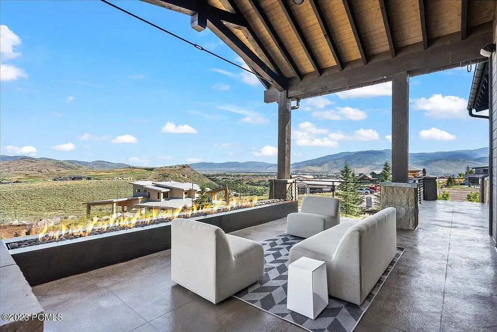 7672 East Moon Dance Circle Home in Heber, Utah. Discover the epitome of modern mountain living within the prestigious gated enclave of Victory Ranch. This unique custom home offers unparalleled views throughout the changing seasons, inviting residents to reconnect with nature and relish in top-tier amenities. Experience the perfect multigenerational mountain retreat, seamlessly blending indoor and outdoor living. With direct access to Victory Ranch's extensive backcountry trails, outdoor adventures are just steps away.