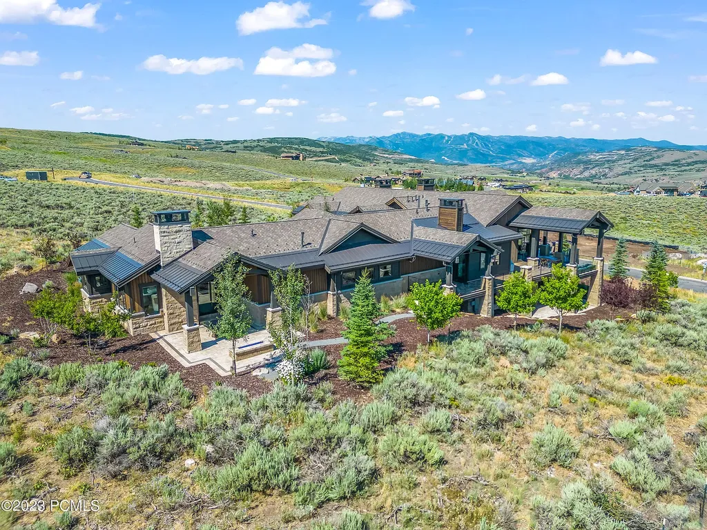 7672 East Moon Dance Circle Home in Heber, Utah. Discover the epitome of modern mountain living within the prestigious gated enclave of Victory Ranch. This unique custom home offers unparalleled views throughout the changing seasons, inviting residents to reconnect with nature and relish in top-tier amenities. Experience the perfect multigenerational mountain retreat, seamlessly blending indoor and outdoor living. With direct access to Victory Ranch's extensive backcountry trails, outdoor adventures are just steps away.