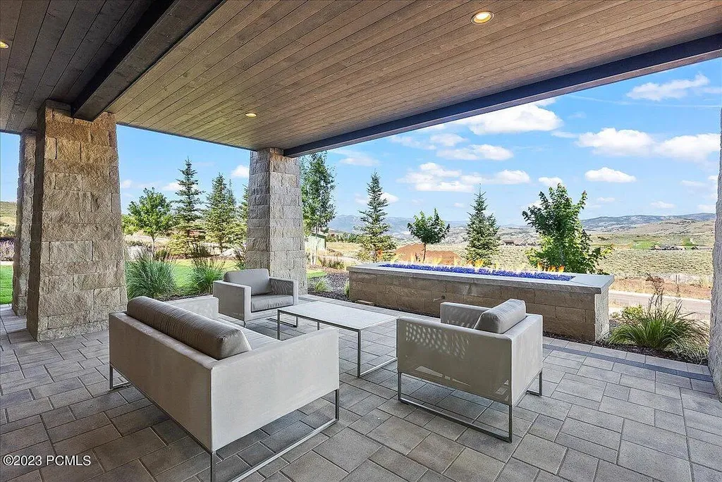 7672 East Moon Dance Circle Home in Heber, Utah. Discover the epitome of modern mountain living within the prestigious gated enclave of Victory Ranch. This unique custom home offers unparalleled views throughout the changing seasons, inviting residents to reconnect with nature and relish in top-tier amenities. Experience the perfect multigenerational mountain retreat, seamlessly blending indoor and outdoor living. With direct access to Victory Ranch's extensive backcountry trails, outdoor adventures are just steps away.