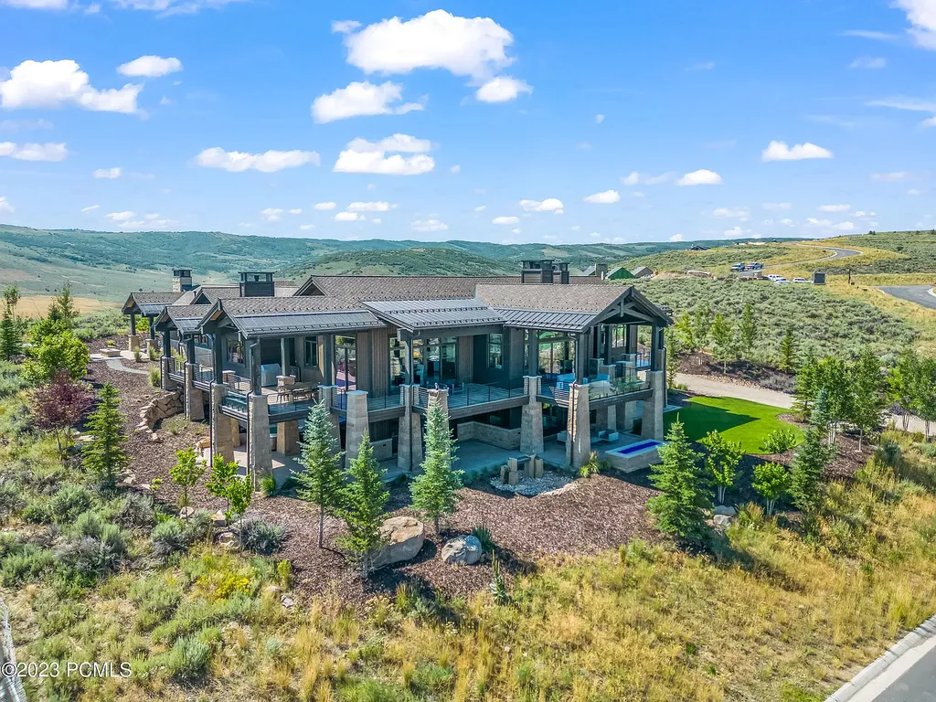 7672 East Moon Dance Circle Home in Heber, Utah. Discover the epitome of modern mountain living within the prestigious gated enclave of Victory Ranch. This unique custom home offers unparalleled views throughout the changing seasons, inviting residents to reconnect with nature and relish in top-tier amenities. Experience the perfect multigenerational mountain retreat, seamlessly blending indoor and outdoor living. With direct access to Victory Ranch's extensive backcountry trails, outdoor adventures are just steps away.