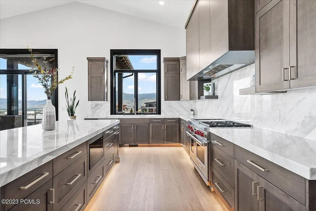 7672 East Moon Dance Circle Home in Heber, Utah. Discover the epitome of modern mountain living within the prestigious gated enclave of Victory Ranch. This unique custom home offers unparalleled views throughout the changing seasons, inviting residents to reconnect with nature and relish in top-tier amenities. Experience the perfect multigenerational mountain retreat, seamlessly blending indoor and outdoor living. With direct access to Victory Ranch's extensive backcountry trails, outdoor adventures are just steps away.