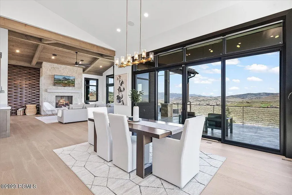 7672 East Moon Dance Circle Home in Heber, Utah. Discover the epitome of modern mountain living within the prestigious gated enclave of Victory Ranch. This unique custom home offers unparalleled views throughout the changing seasons, inviting residents to reconnect with nature and relish in top-tier amenities. Experience the perfect multigenerational mountain retreat, seamlessly blending indoor and outdoor living. With direct access to Victory Ranch's extensive backcountry trails, outdoor adventures are just steps away.