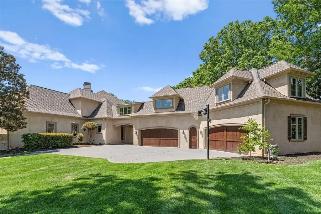 8600 Fairview Road Home in Charlotte, North Carolina. Discover the epitome of luxury living at Fairview Manor Estate in the coveted Carmel Park neighborhood. This gated 1.27-acre property boasts a stunning great room with a 2-story fireplace, exquisite millwork, and floor-to-ceiling windows. 