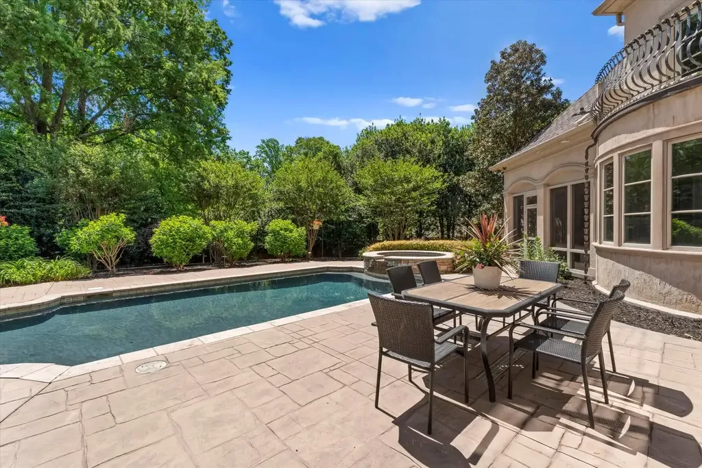 8600 Fairview Road Home in Charlotte, North Carolina. Discover the epitome of luxury living at Fairview Manor Estate in the coveted Carmel Park neighborhood. This gated 1.27-acre property boasts a stunning great room with a 2-story fireplace, exquisite millwork, and floor-to-ceiling windows. 