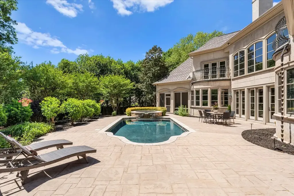 8600 Fairview Road Home in Charlotte, North Carolina. Discover the epitome of luxury living at Fairview Manor Estate in the coveted Carmel Park neighborhood. This gated 1.27-acre property boasts a stunning great room with a 2-story fireplace, exquisite millwork, and floor-to-ceiling windows. 