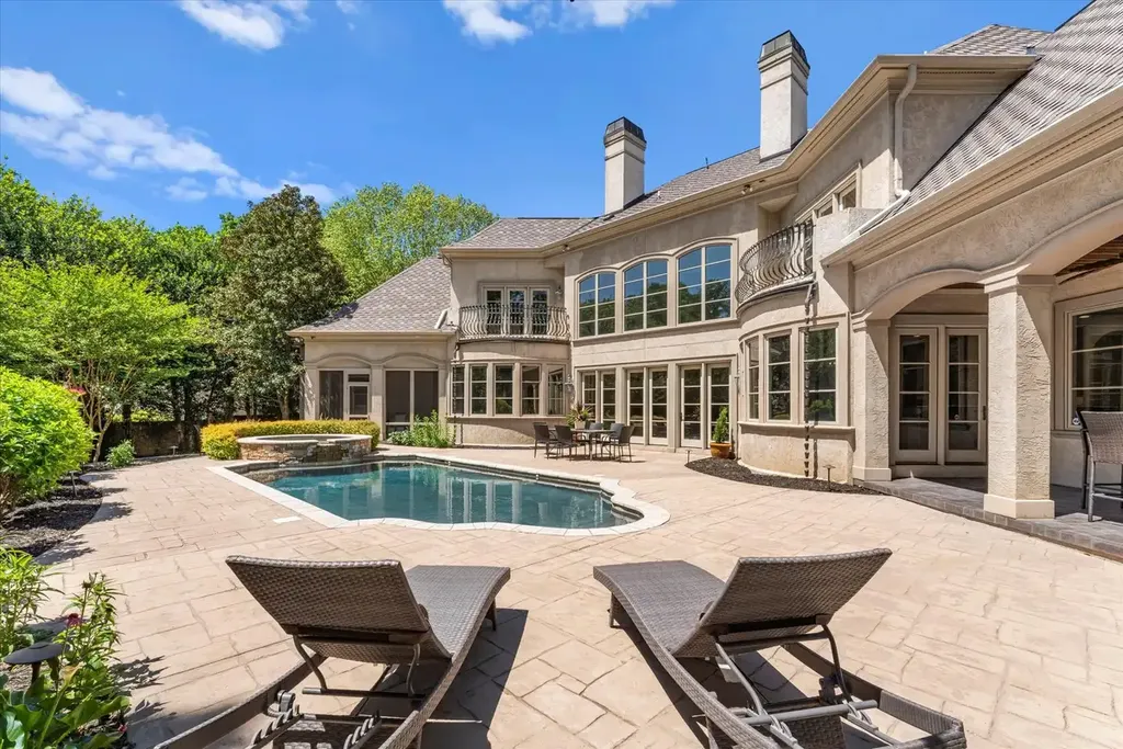 8600 Fairview Road Home in Charlotte, North Carolina. Discover the epitome of luxury living at Fairview Manor Estate in the coveted Carmel Park neighborhood. This gated 1.27-acre property boasts a stunning great room with a 2-story fireplace, exquisite millwork, and floor-to-ceiling windows. 
