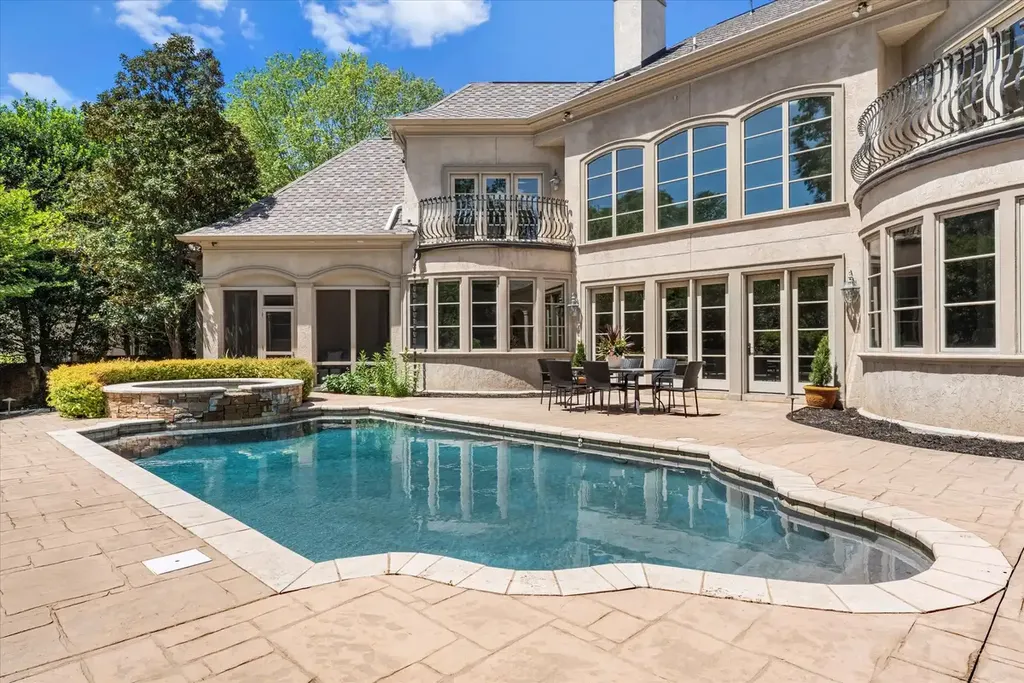 8600 Fairview Road Home in Charlotte, North Carolina. Discover the epitome of luxury living at Fairview Manor Estate in the coveted Carmel Park neighborhood. This gated 1.27-acre property boasts a stunning great room with a 2-story fireplace, exquisite millwork, and floor-to-ceiling windows. 