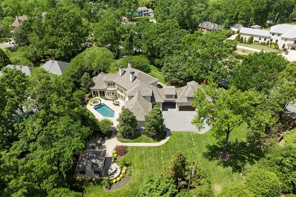 8600 Fairview Road Home in Charlotte, North Carolina. Discover the epitome of luxury living at Fairview Manor Estate in the coveted Carmel Park neighborhood. This gated 1.27-acre property boasts a stunning great room with a 2-story fireplace, exquisite millwork, and floor-to-ceiling windows. 