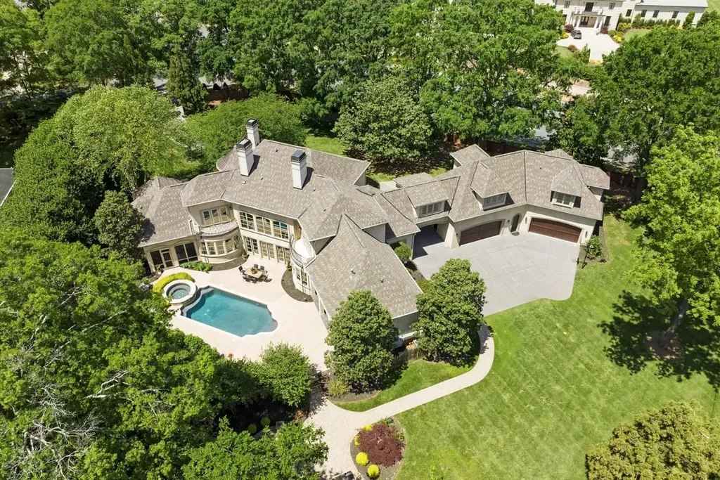 8600 Fairview Road Home in Charlotte, North Carolina. Discover the epitome of luxury living at Fairview Manor Estate in the coveted Carmel Park neighborhood. This gated 1.27-acre property boasts a stunning great room with a 2-story fireplace, exquisite millwork, and floor-to-ceiling windows. 