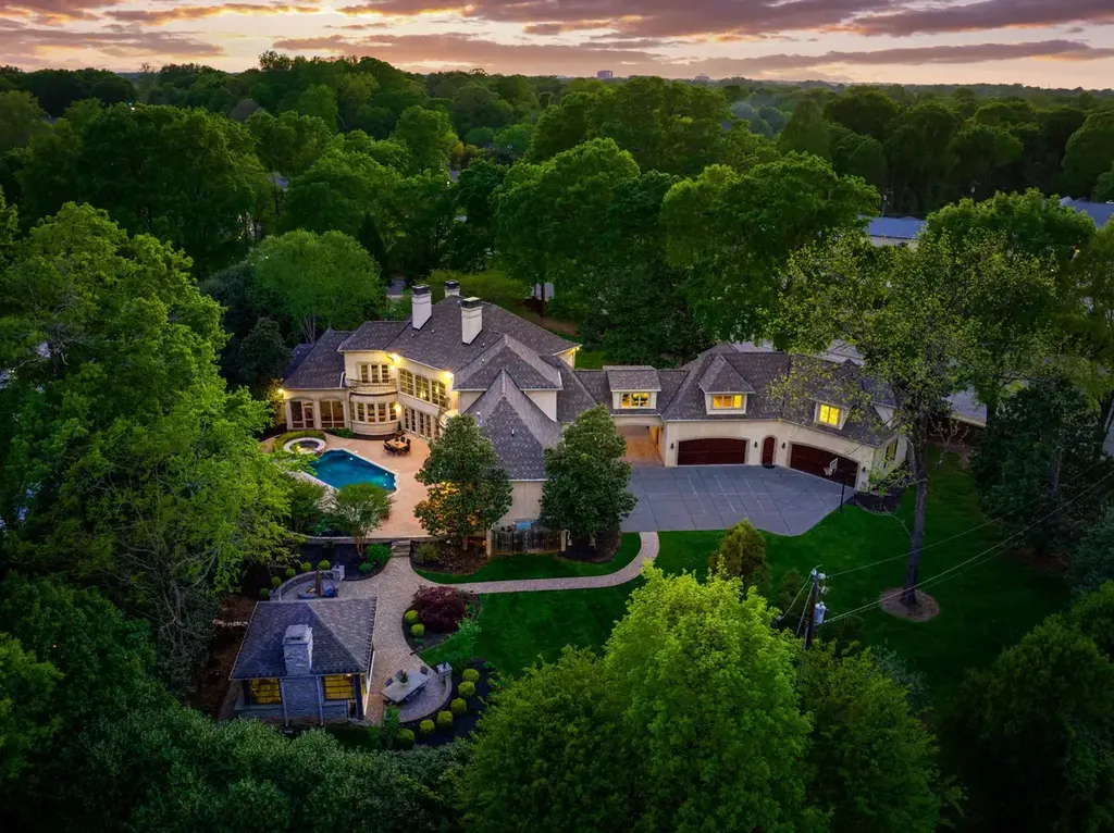 8600 Fairview Road Home in Charlotte, North Carolina. Discover the epitome of luxury living at Fairview Manor Estate in the coveted Carmel Park neighborhood. This gated 1.27-acre property boasts a stunning great room with a 2-story fireplace, exquisite millwork, and floor-to-ceiling windows. 