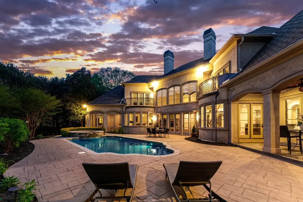 8600 Fairview Road Home in Charlotte, North Carolina. Discover the epitome of luxury living at Fairview Manor Estate in the coveted Carmel Park neighborhood. This gated 1.27-acre property boasts a stunning great room with a 2-story fireplace, exquisite millwork, and floor-to-ceiling windows. 