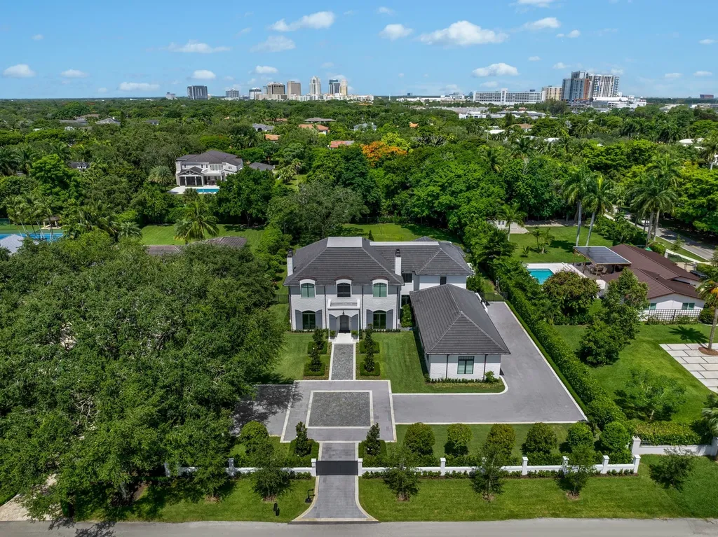 8840 SW 61st Court Home in Pinecrest, Florida. Explore this exquisite European-inspired home in N. Pinecrest, boasting 7 bedrooms and 7.5 bathrooms. From the formal living room with a wine cellar to the showstopper kitchen, this residence exudes elegance and sophistication.
