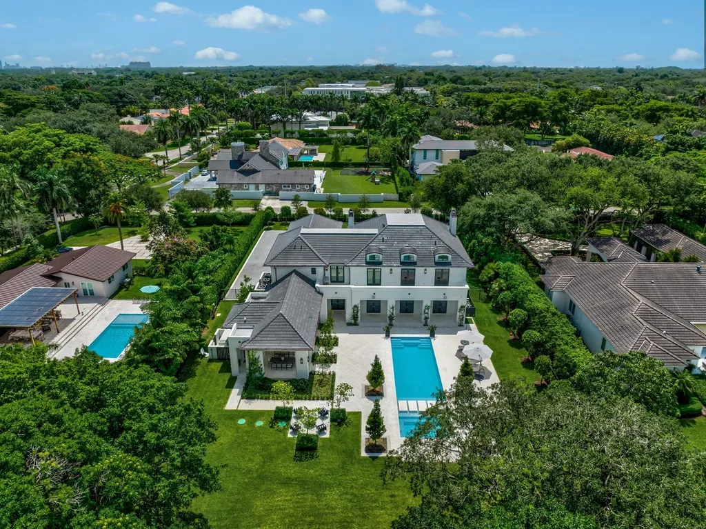 8840 SW 61st Court Home in Pinecrest, Florida. Explore this exquisite European-inspired home in N. Pinecrest, boasting 7 bedrooms and 7.5 bathrooms. From the formal living room with a wine cellar to the showstopper kitchen, this residence exudes elegance and sophistication.