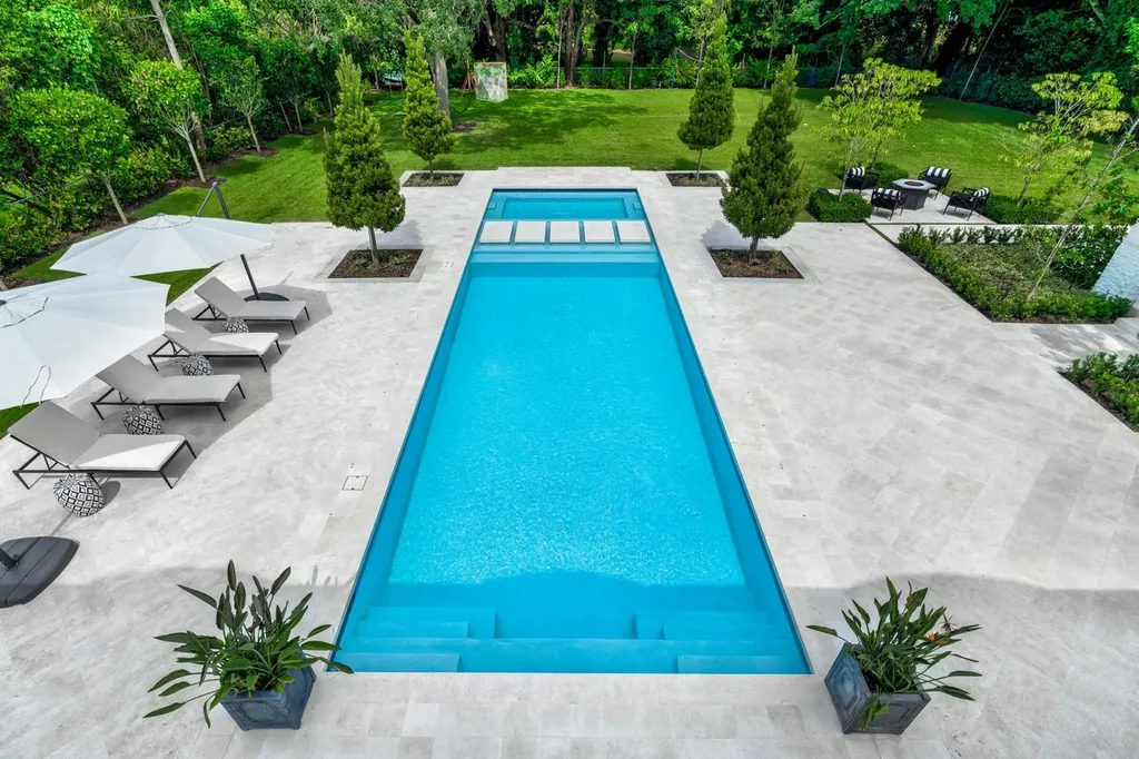 8840 SW 61st Court Home in Pinecrest, Florida. Explore this exquisite European-inspired home in N. Pinecrest, boasting 7 bedrooms and 7.5 bathrooms. From the formal living room with a wine cellar to the showstopper kitchen, this residence exudes elegance and sophistication.