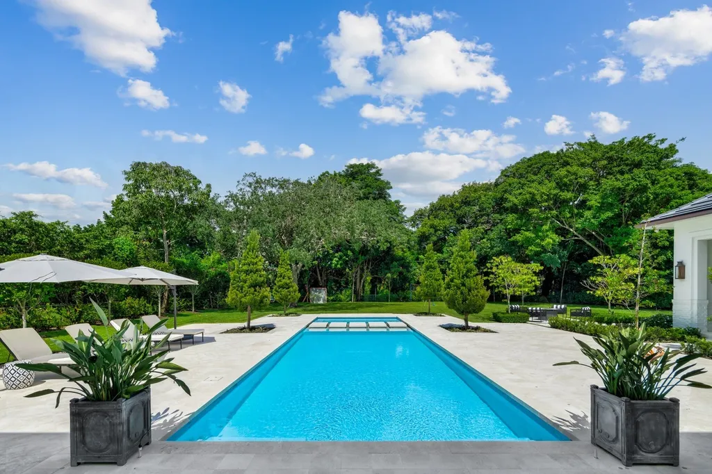 8840 SW 61st Court Home in Pinecrest, Florida. Explore this exquisite European-inspired home in N. Pinecrest, boasting 7 bedrooms and 7.5 bathrooms. From the formal living room with a wine cellar to the showstopper kitchen, this residence exudes elegance and sophistication.