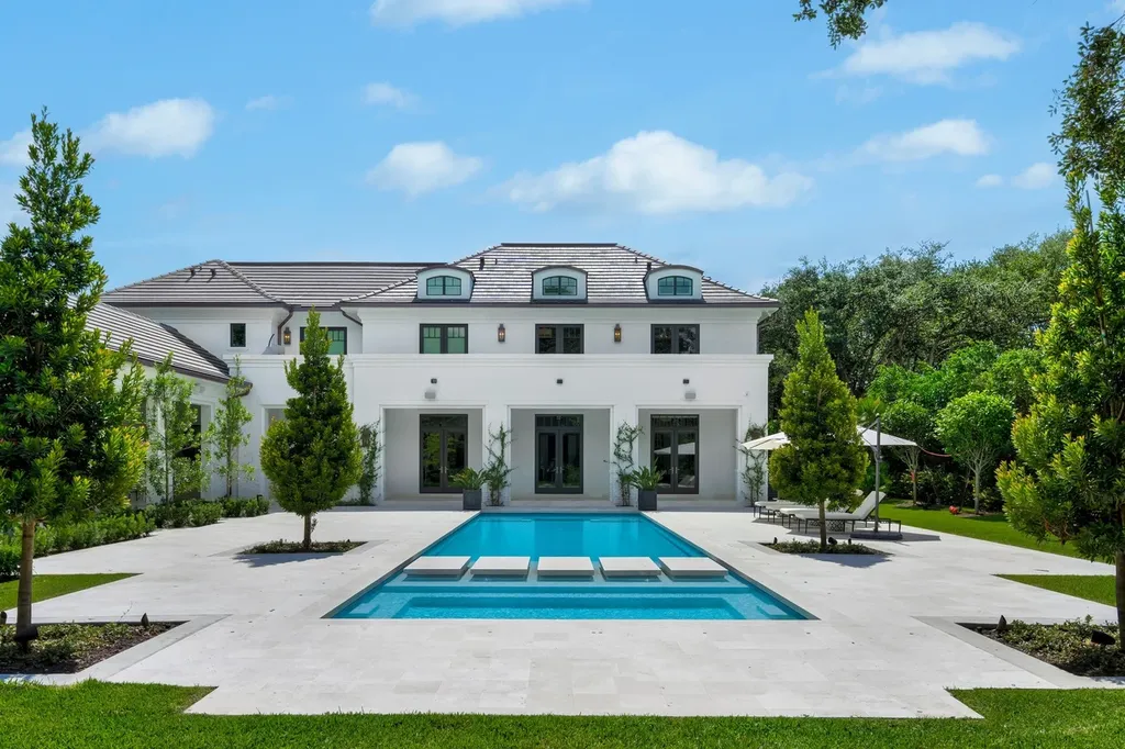 8840 SW 61st Court Home in Pinecrest, Florida. Explore this exquisite European-inspired home in N. Pinecrest, boasting 7 bedrooms and 7.5 bathrooms. From the formal living room with a wine cellar to the showstopper kitchen, this residence exudes elegance and sophistication.