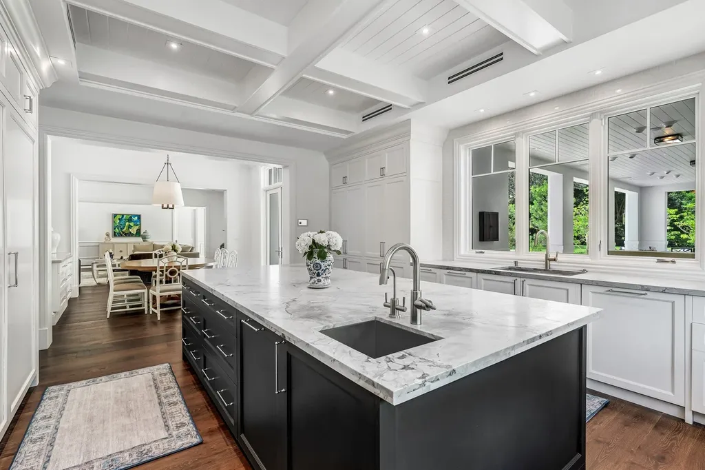 8840 SW 61st Court Home in Pinecrest, Florida. Explore this exquisite European-inspired home in N. Pinecrest, boasting 7 bedrooms and 7.5 bathrooms. From the formal living room with a wine cellar to the showstopper kitchen, this residence exudes elegance and sophistication.